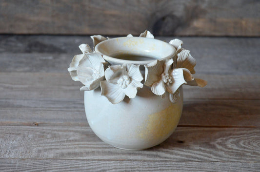 White spherical vase with Cornus flower