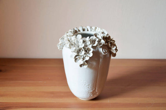 Romantic stoneware vase with white hydrangea flowers